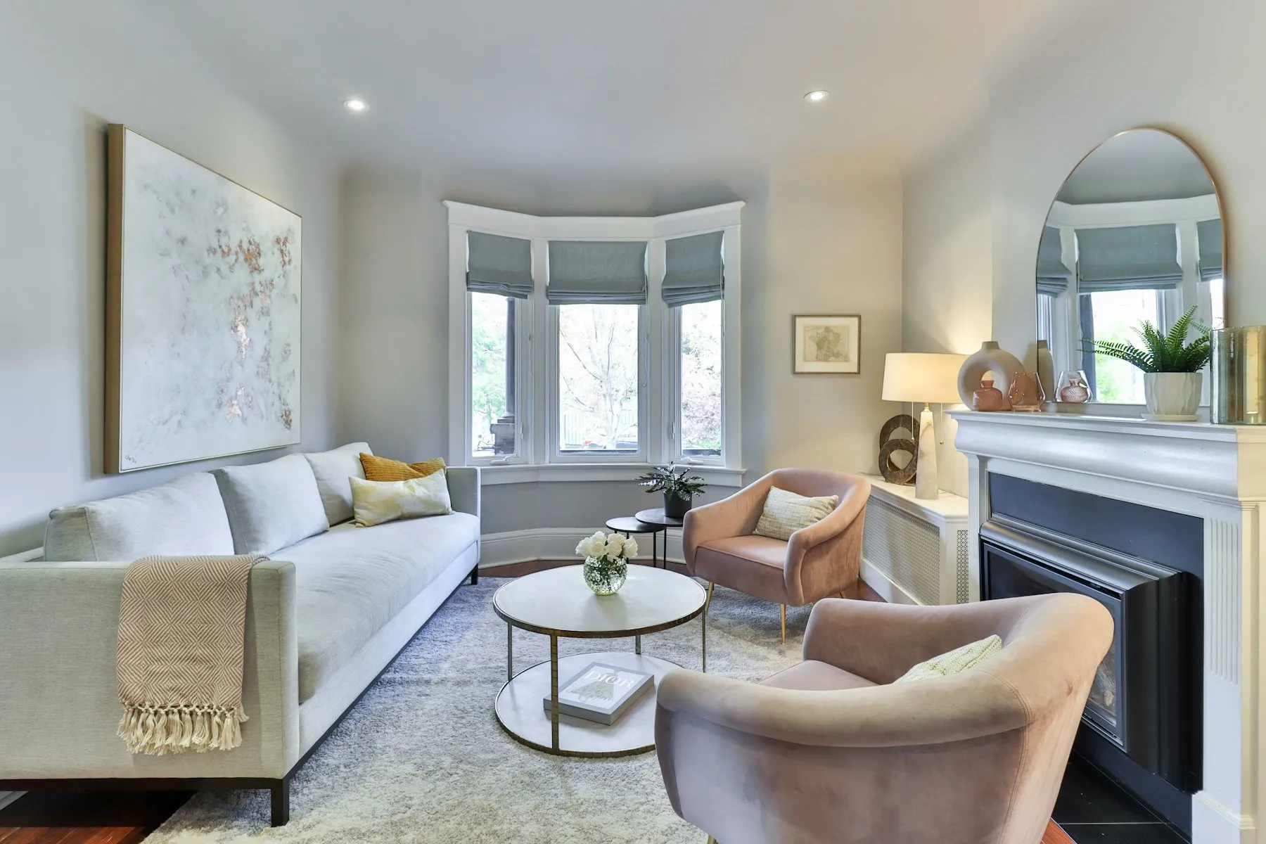 A reception room with a fireplace and a deep bay window